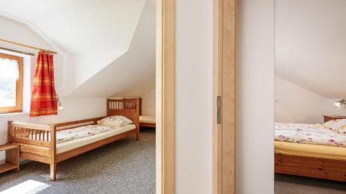 a bedroom with two beds and a window at Ferienhaus Zillendorf in Zillendorf