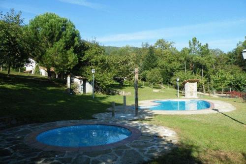 a small swimming pool in a yard with trees at Allotjaments Colomer-Cullell in Bas