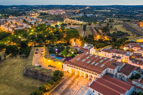 an aerial view of a town at night at Hotel Sao Joao De Deus by RIDAN Hotels in Elvas