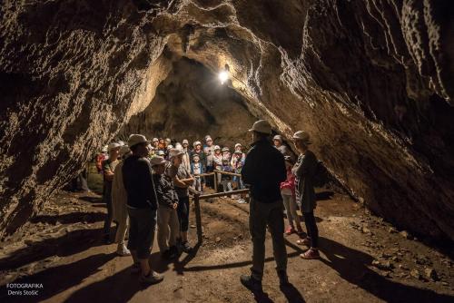 a group of people standing in a cave at Studio apartments Kaya in Čatrnja