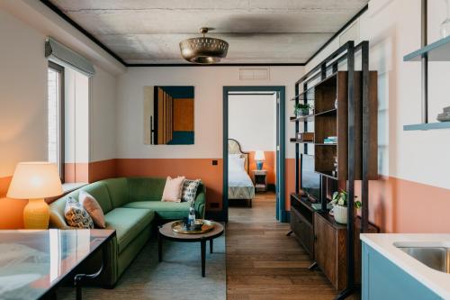 a living room filled with furniture and a window at Hotel BOAT & CO in Amsterdam