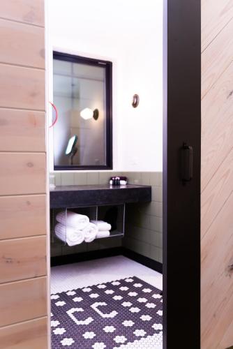 a bathroom with a sink and a mirror at Cotton Court Hotel, by Valencia Hotel Collection in Lubbock