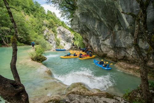a group of people are rafting down a river at Studio apartments Kaya in Čatrnja