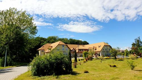 a group of houses with cows in the grass at Willa Park in Ostrowiec Świętokrzyski