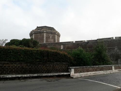 a brick wall with a building in the background at Casetta la Terrazza in Civita Castellana