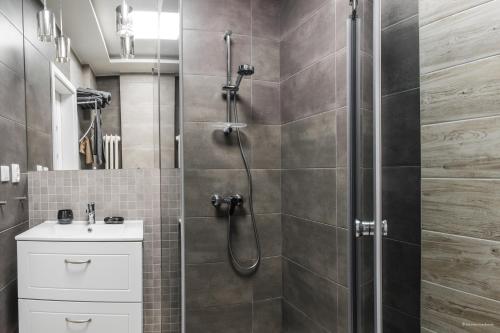 a bathroom with a shower and a sink at Pomeranian House in Gdańsk