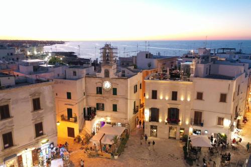 an aerial view of a city with a clock tower at Sei Stelle Mama in Polignano a Mare