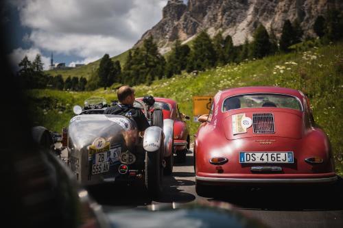 a man standing next to an old car and a motorcycle at Hotel-Garni Appartement Gartenheim in Schenna