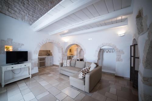 a living room filled with furniture and a tv at Charming Trulli in Alberobello