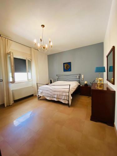 a bedroom with a bed and a chandelier at CASA GARIBALDI 162 in Leverano