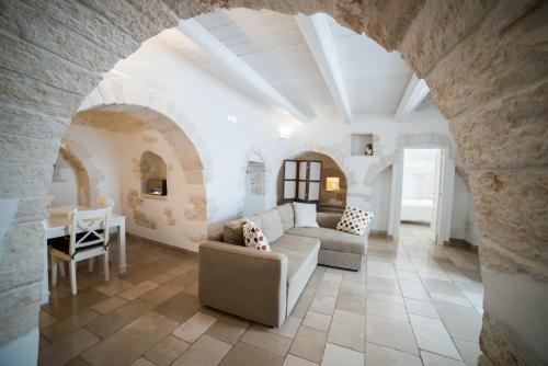 a living room filled with furniture and a stone wall at Charming Trulli in Alberobello