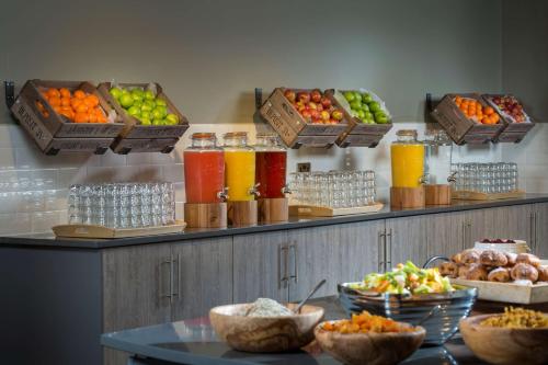 a kitchen filled with lots of fruits and vegetables at Radisson Hotel and Conference Centre London Heathrow in Hillingdon