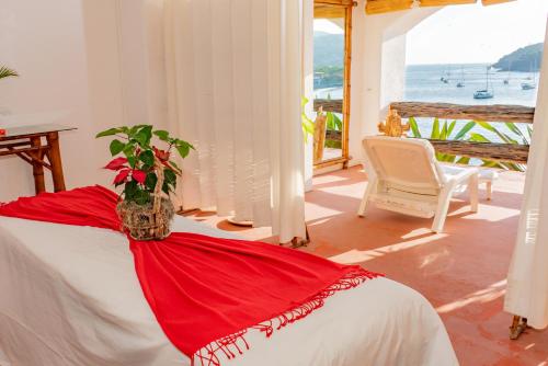 a bedroom with a bed with a plant on it at Hotel Irma in Zihuatanejo