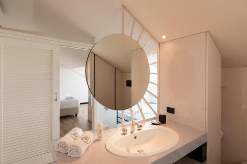 a bathroom with a sink and a mirror at Loft Cedro, by R Collection Apartments in Como
