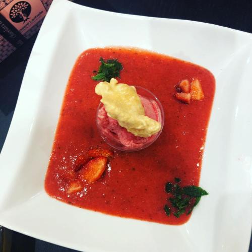 a white plate with a red sauce with a drink at Le Blockhaus de Domléger et Spa in Domléger