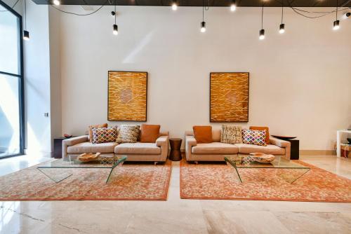 a living room with two couches and two tables at Harmony Medical Suites ChinaTown in Boston