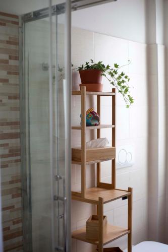 a wooden shelf in a bathroom with a shower at L'Ancora B&B in Montesilvano