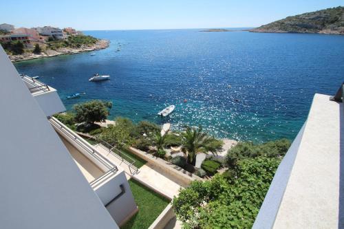 a view of the ocean from a balcony of a building at Villa Lavanda Deluxe in Rogoznica