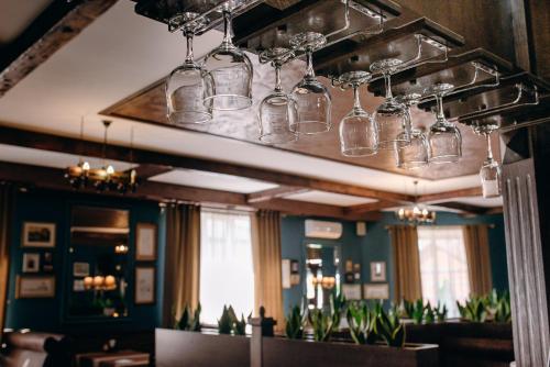 a restaurant with glasses hanging from the ceiling at Globus Hotel in Ternopil