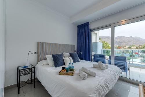 a bedroom with a large bed with towels on it at Deisy Apartments in Puerto de Mogán