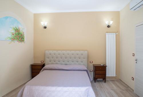 1 dormitorio con 1 cama grande y 2 mesitas de noche en Mandevilla Home en Caiazzo