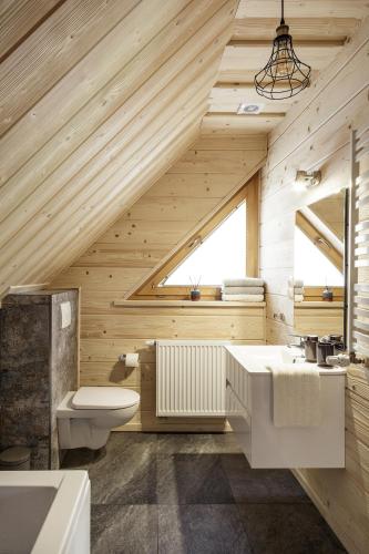 a wooden bathroom with a sink and a toilet at Bukowy Raj in Wisła