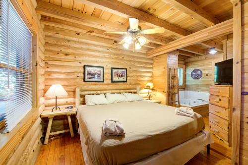 a log cabin bedroom with a bed and a tub at Bear Naked in Cove Creek Cascades