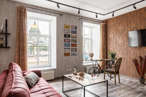 a living room with a couch and a table at Agent Flat Apartment in Saint Petersburg