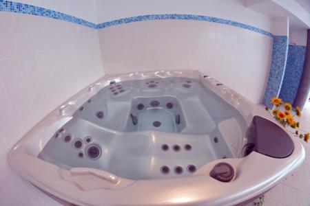 a white bath tub in a white bathroom at Villa Clorè Hotel & Spa in Lama Mocogno