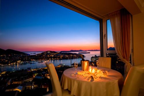 a table in a room with a view of a city at Apartments Dilberovic in Dubrovnik