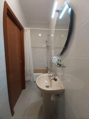 a bathroom with a sink and a mirror at Pension Lorea in San Sebastián