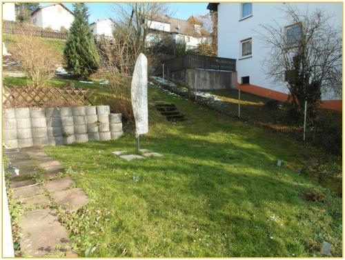 a sculpture in the grass in a yard at Ferienwohnung Zauberhaft in Bad Soden-Salmünster