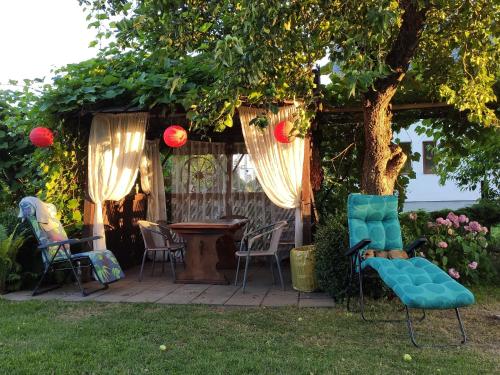 a patio with chairs and a table under a tree at Agroturystyka u Pruszyńskich in Mońki