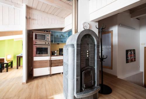 a kitchen with a fireplace in the middle of a room at White Tower of Love in Bressanone