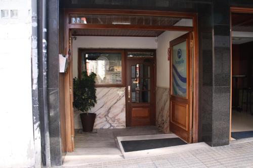 an open door of a building with a potted plant at Hostal Adelia in A Coruña