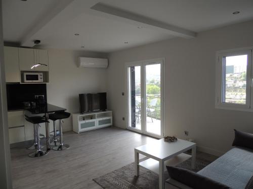a living room with a couch and a table at Apartamento Amarante - Vista São Gonçalo in Amarante