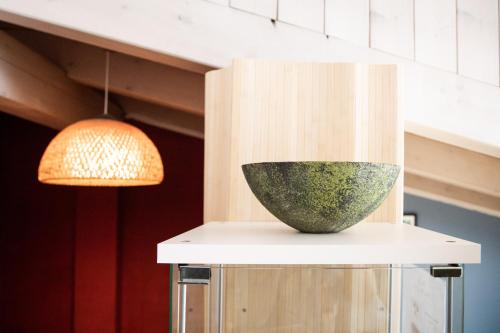 a vase sitting on a counter next to a lamp at White Tower of Love in Bressanone