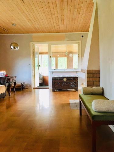 a large living room with a wooden ceiling at Arthome Småland in Ruda