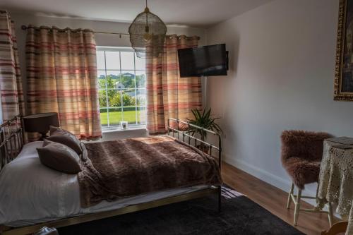 a bedroom with a bed and a window at The Knock Guest house in Dunhill