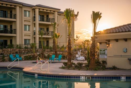a patio with a pool, chairs, and a pool table at Estancia Resort in St. George