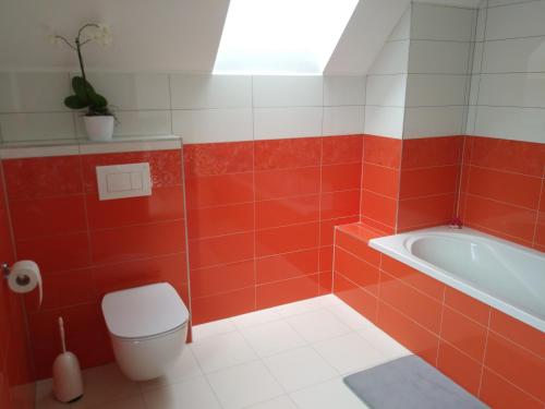 a bathroom with a tub and a toilet and a sink at Počitniška hiša Nad Sočo in Bovec