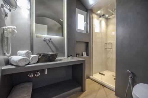 a bathroom with a sink and a shower at Sea & Olives Suites Hotel and Villas in Plaka
