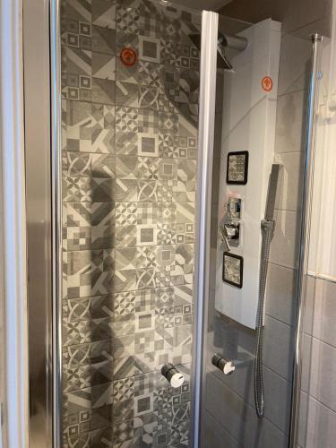 a shower in a bathroom with a mosaic wall at Rigoletto Holiday Home,Centrocittà Palermo in Palermo
