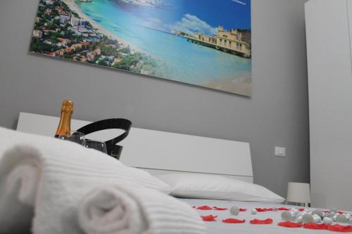 RIGOLETTO HOLIDAY HOME في باليرمو: غرفة نوم بسرير مع صورة على الحائط