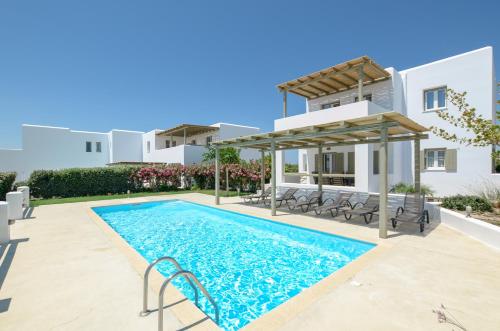 a swimming pool in front of a villa at Sea & Olives Suites Hotel and Villas in Plaka