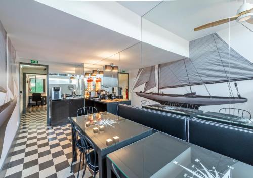 a kitchen with a table and a boat on the wall at Oporto Street Fonte Taurina - Riverfront Suites in Porto