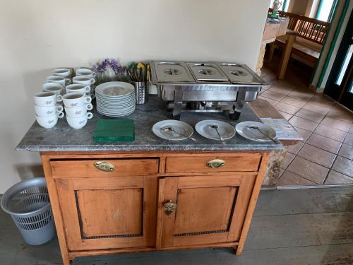 a kitchen with a stove and plates on a counter at Na Kopečku AD 1795 - penzion s restaurací a wellness v Podkrkonoší in Dvůr Králové nad Labem