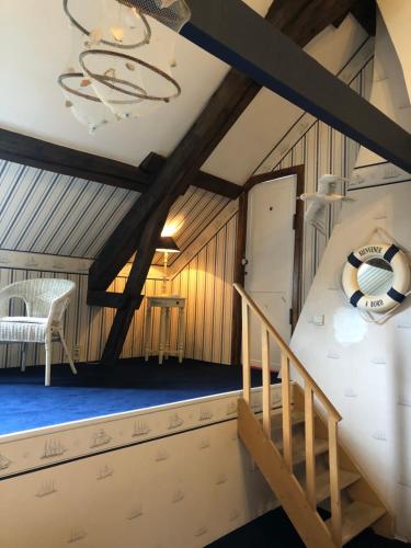 a room with a staircase and a bed with a soccer ball on it at Château Les Tourelles in Bertrix