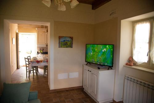 a living room with a flat screen tv on a wall at La Beppa - Casa Vacanza in Pontremoli