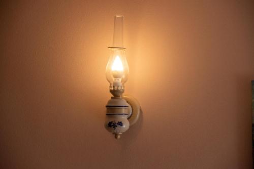 a light on a wall with a light on it at La Beppa - Casa Vacanza in Pontremoli
